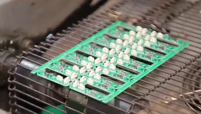 Populated circuit boards on a conveyor